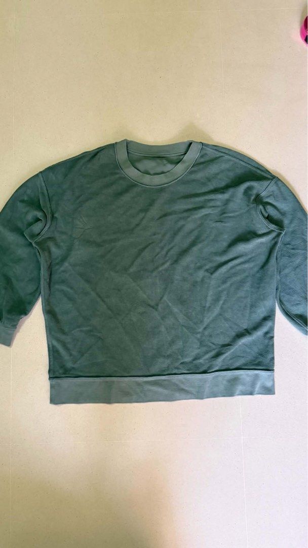 Lululemon jacket (Category: Activewear) located in Singapore. Submitted by kenmarjorie (Listing ID 1446353683, Image 3). Description: Used no odor no stain no damage add for mailing Lululemon Perfectly Oversized Crew Pullover Description - size 12 - no damage - desaturated Blue-Green Earth tone - 100% cotton.