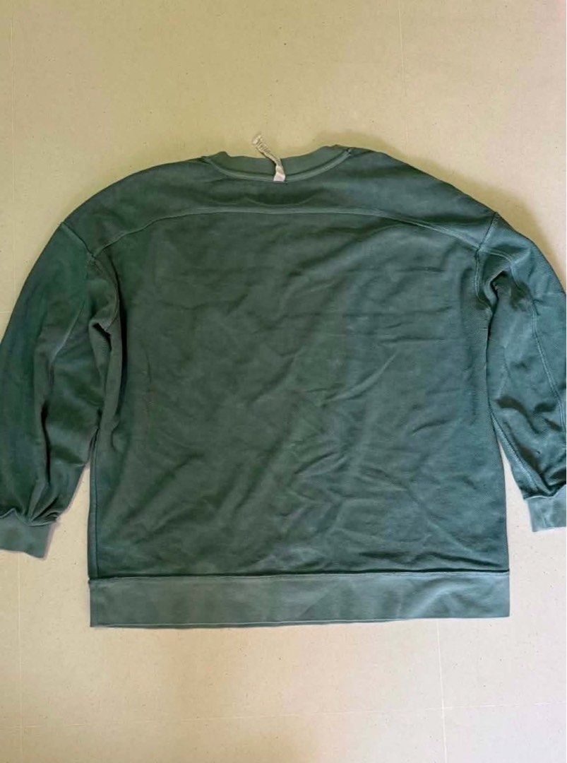Lululemon jacket (Category: Activewear) located in Singapore. Submitted by kenmarjorie (Listing ID 1446353683, Image 2). Description: Used no odor no stain no damage add for mailing Lululemon Perfectly Oversized Crew Pullover Description - size 12 - no damage - desaturated Blue-Green Earth tone - 100% cotton.