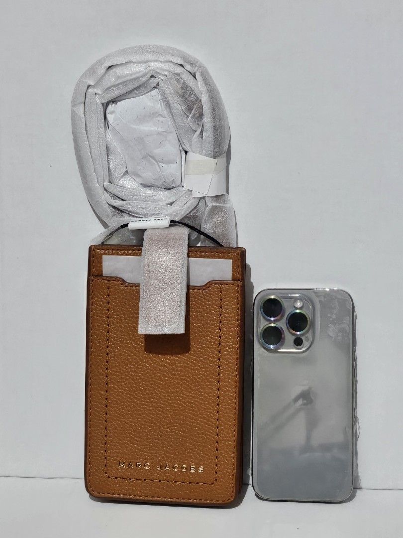 Marc Jacobs Leather Cardholder with Strap - Tan (Category: Luxury Bags & Wallets) located in Mandaluyong City. Submitted by coffeecatsph (Listing ID 1446530522, Image 3). Description: - Genuine Marc Jacobs tan leather cardholder - Features card slots for easy organization - Includes a detachable and adjustable strap - Brand new with tag still attached - Phone in photo for size reference.