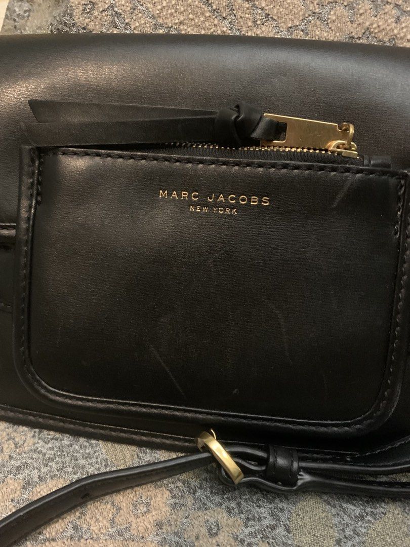 Marc Jacobs Madison Black Leather Crossbody Bag (Category: Luxury Bags & Wallets) located in Paranaque City. Submitted by imnotlizzie (Listing ID 1446484094, Image 2). Description: - Authentic Marc Jacobs black leather crossbody bag - Front zip pocket - Gold hardware - Adjustable strap - With light scratches - Available for delivery via Lalamove, Grab, or GoGo Express.