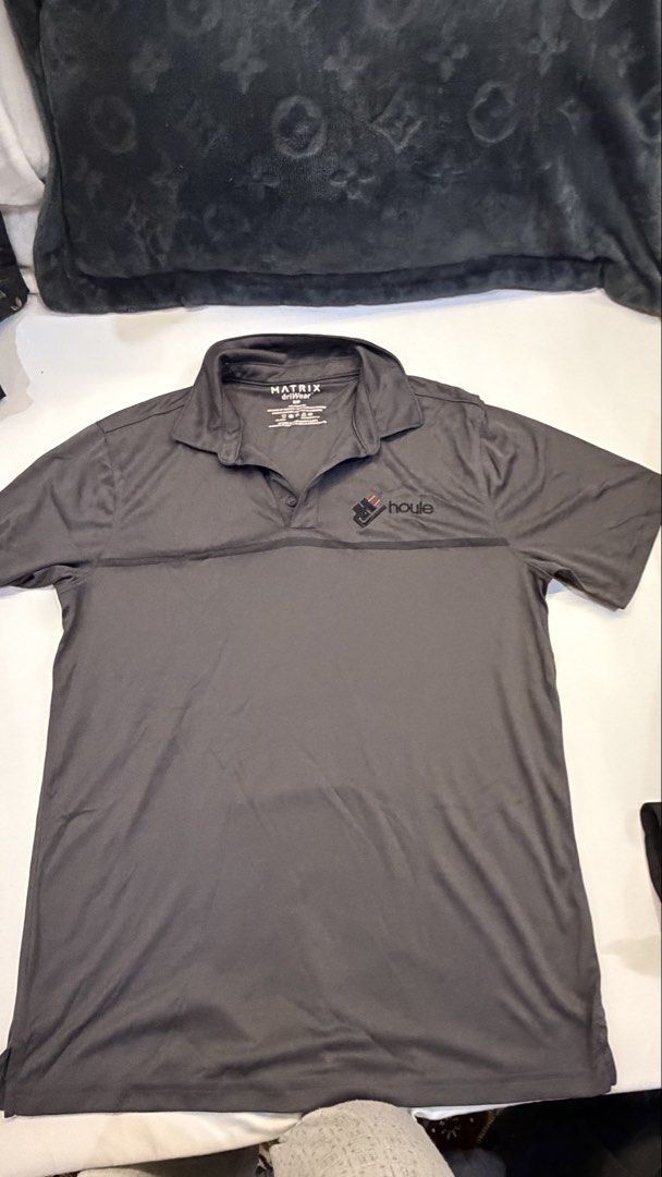 Matrix Houle Electric Grey Polo Shirt (Category: Tshirts & Polo Shirts ) located in Makati City. Submitted by herloqxury (Listing ID 1446393400, Image 1). Description: - Grey Matrix polo shirt - Features Houle Electric logo on chest - Short sleeves with collared neckline - Button closure - Likely performance fabric - Suitable for work or casual wear.