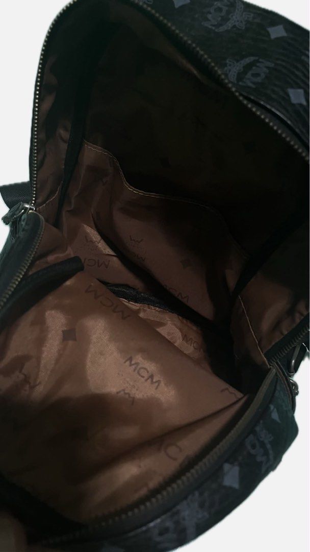 MCM Studded Monogram Backpack Black (Category: Luxury Bags & Wallets) located in Makati City. Submitted by preloved_plc (Listing ID 1446359856, Image 2). Description: - Authentic black MCM backpack - Signature monogram print - Decorative silver-tone studs on front - Main compartment with interior pocket - Adjustable shoulder straps - Minor signs of wear on hardware and straps.