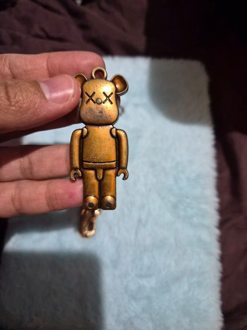 Merlion & Bearbrick Keychain Charms (Category: Character Goods) located in Mandaue City. Submitted by chuchi152615 (Listing ID 1446516962, Image 3). Description: - Set of 2 unique keychain charms - Vintage gold-tone finish - Features a Singapore Merlion icon - Includes a Bearbrick-style charm with X eyes - Ideal for decorating bags or keys - Great collectible pieces.
