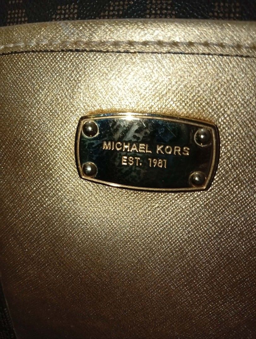 Michael Kors Monogram Shoulder Bag Gold Accents (Category: Luxury Bags & Wallets) located in Quezon City. Submitted by kinopipanda (Listing ID 1446530886, Image 3). Description: - Authentic Michael Kors shoulder bag in classic brown. - Features the iconic MK monogram print all over. - Elegant gold accent panel on the front for a touch of luxury. - Adjustable strap for comfortable, customized wear. - Generously sized interior, ideal for carrying y