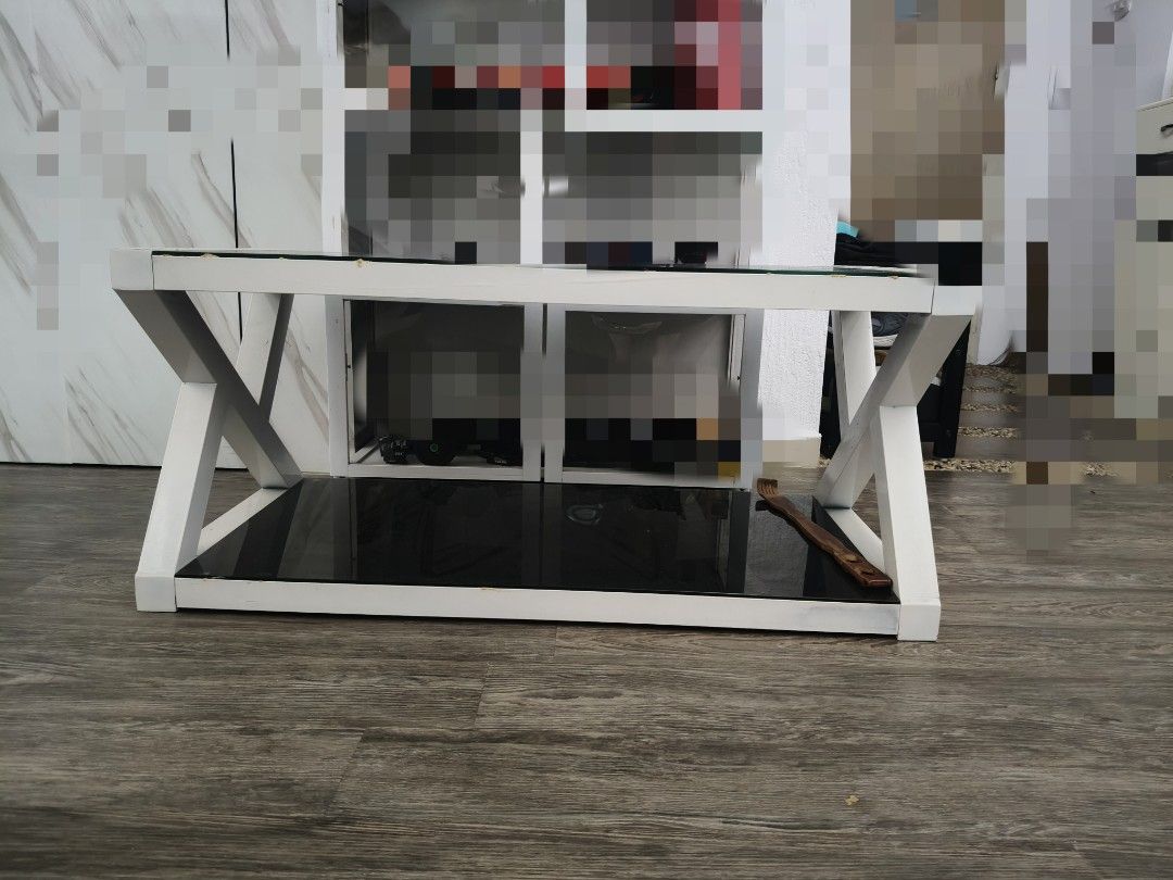 Coffee Table (Category: Tables & Sets) located in Singapore. Submitted by ridenslide (Listing ID 1446458243, Image 1). Description: well used coffee table. Slightly negotiable. tempered glass / metal condition 8/10. measurements: Length: 1m (1000cm) Width: 50cm Height: 45cm Buyer to arrange own transport. White coffee table - Sleek black glass top - Unique criss-cross base design - Suitable size for living room - Easy to clean surface - Selling a