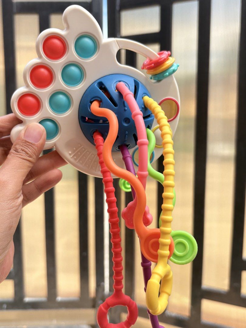 Montessori Sensory Pull String Toy for Babies (Category: Infant Playtime) located in Manila. Submitted by biboystoyhouse (Listing ID 1446441356, Image 3). Description: - Fun sensory toy for babies - Features colorful pull strings and textured surfaces - Excellent for developing fine motor skills - Encourages sensory exploration with engaging colors and textures - Designed for small hands to grasp and manipulate easily - Perfect travel companion f