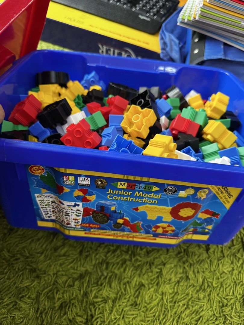 Morphun Junior Model Construction Building Blocks Set (Category: Lego & Building Sets) located in Gombak. Submitted by haslanhrnkl (Listing ID 1446354469, Image 2). Description: - Morphun Junior construction set - Includes colorful building blocks - Comes with a blue storage bin - Features instruction booklet with model ideas (cars, dragons, helicopters, etc.) - Encourages creative play and learning - Suitable for children aged 4 and above.