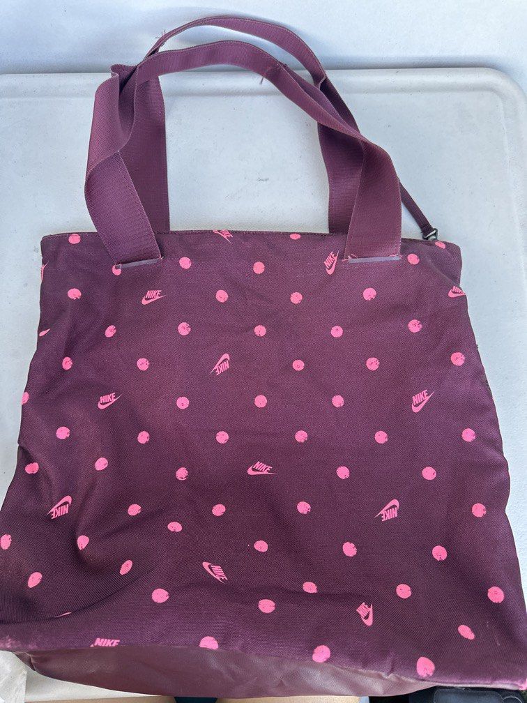 Nike Radiate Training Tote Bag (Category: Tote Bags) located in Manila. Submitted by classywardrobemanila (Listing ID 1446444496, Image 3). Description: No issue. Nike Radiate Training Tote Bag in the “Night Maroon/Pink” polka dot colorway Dimensions: Approximately 16 in H x 16 in W x 6 in D (41 cm x 39 cm x 15 cm). Material: Outer shell and lining are made of 100% Polyester. Main Closure: Sturdy top-zippered compartment providing wide-open, easy