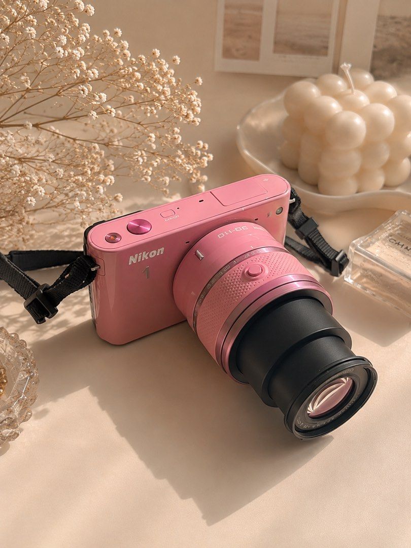 Pink Nikon 1 J1 Mirrorless Camera with Lens (Category: Cameras) located in Caloocan City. Submitted by jammibee_ (Listing ID 1446477746, Image 3). Description: - Cute pink Nikon 1 J1 mirrorless digital camera - Comes with attached lens - Perfect for everyday photos and travel - Easy to use, takes great pictures - Includes a strap, lens, battery, charger, & sd card..
