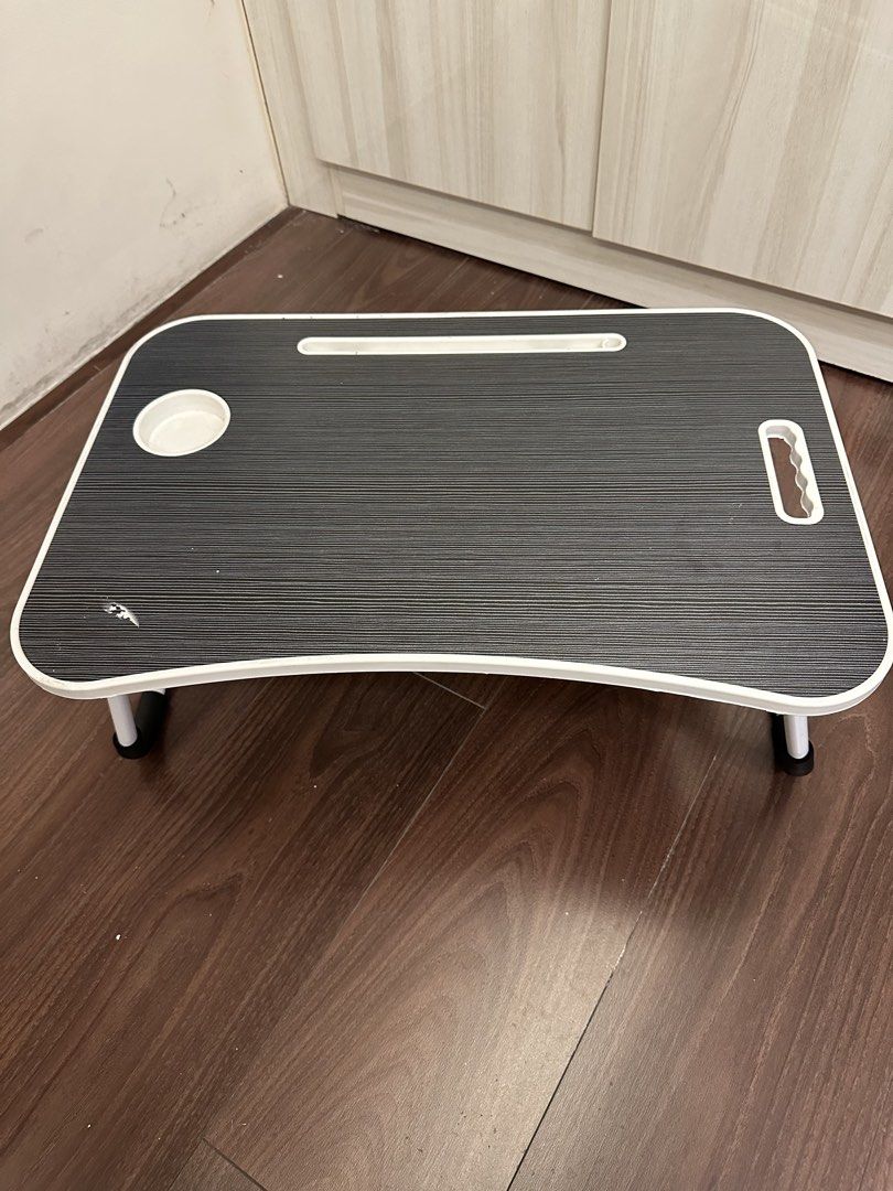 Portable Laptop Bed Tray with Cup Holder (Category: Laptop Bags & Sleeves) located in Quezon City. Submitted by bqchane (Listing ID 1446447962, Image 1). Description: - Convenient lap desk for work or relaxation - Built-in cup holder - Slot for tablet or phone - Foldable legs for easy storage - Ideal for using laptop in bed or on the couch - Side handle for easy carrying.
