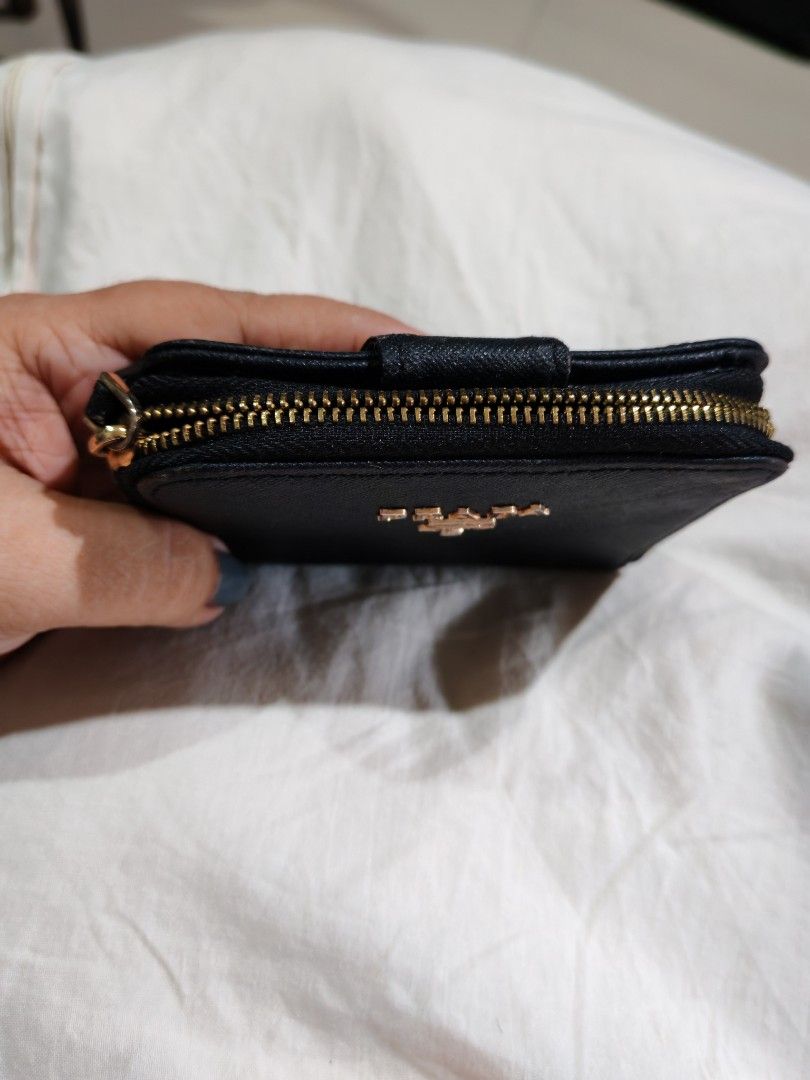 Prada Black Saffiano Wallet (Category: Luxury Bags & Wallets) located in Davao. Submitted by athenaprelovedph (Listing ID 1446461036, Image 2). Description: - Prada bifold wallet - Material: Black saffiano leather - Closure: Gold zipper - Interior: Two compartments - Size: Small and compact, fits easily in any bag - Functionality: Great for organizing coins and cards - Condition: Shows some signs of wear on the zipper and corners.
