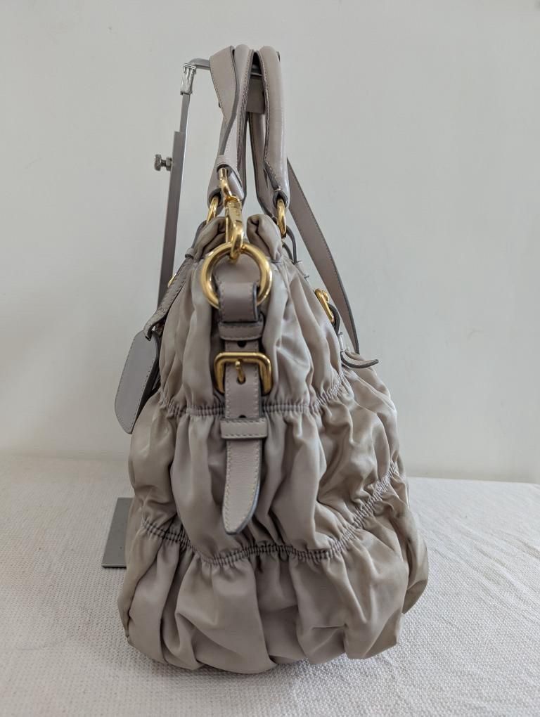 Prada Gaufre Ruched Tote Bag Grey (Category: Luxury Bags & Wallets) located in Manila. Submitted by dmsaguas (Listing ID 1446373091, Image 3). Description: - Authentic Grey Prada Gaufre Bag - Signature all-over ruching detail - Overall shiny gold hardware - includes care cards - Includes a detachable shoulder strap for versatility.