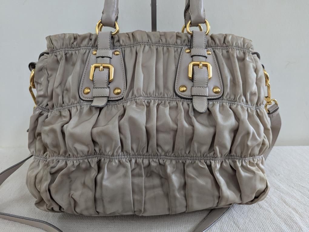 Prada Gaufre Ruched Tote Bag Grey (Category: Luxury Bags & Wallets) located in Manila. Submitted by dmsaguas (Listing ID 1446373091, Image 2). Description: - Authentic Grey Prada Gaufre Bag - Signature all-over ruching detail - Overall shiny gold hardware - includes care cards - Includes a detachable shoulder strap for versatility.