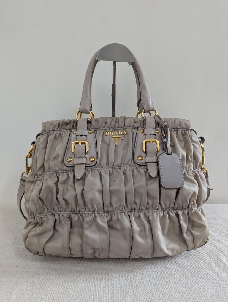 Prada Gaufre Ruched Tote Bag Grey (Category: Luxury Bags & Wallets) located in Manila. Submitted by dmsaguas (Listing ID 1446373091, Image 1). Description: - Authentic Grey Prada Gaufre Bag - Signature all-over ruching detail - Overall shiny gold hardware - includes care cards - Includes a detachable shoulder strap for versatility.