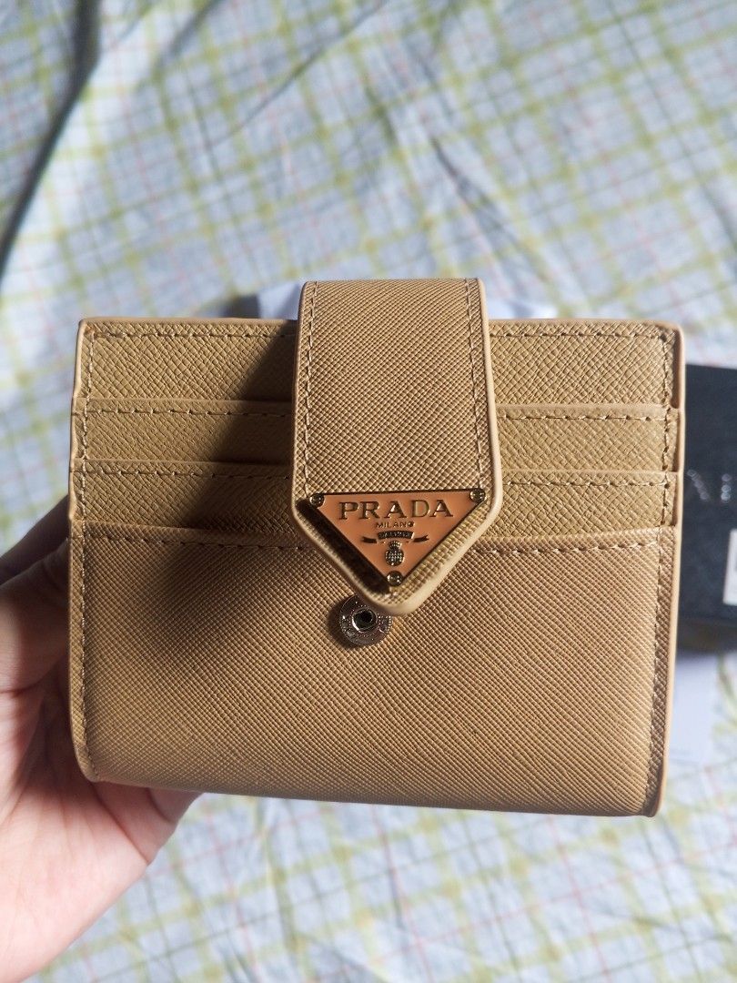 Prada Inspired Saffiano Leather Wallet with Box (Beige) (Category: Wallets & Card holders) located in Manila. Submitted by rhian_04 (Listing ID 1446398749, Image 3). Description: Selling this high-quality Prada inspired compact wallet. Very elegant and perfect for everyday use. Style: Inspired piece (Premium/Top Grade Quality) Material: Saffiano leather texture Color: Beige / Khaki Inclusions: Comes with the box, wrapper, and card as seen in the 