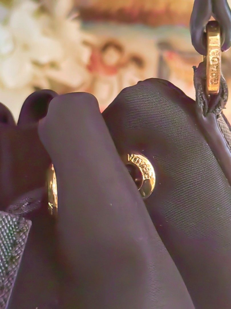 Prada Nylon Drawstring Bucket Bag (Category: Luxury Bags & Wallets) located in Davao. Submitted by gelleevanelli (Listing ID 1446535369, Image 2). Description: PRADA Re-Nylon Mini Drawstring| Black. Fits your whole life (phones, make up, wallet, keys, etc... *Condition:* Pre-loved, Body VGUC Strap, with cracks but not chipping (twilly recommended sa maarte) Missing long strap. Nylon no flaw, no runs Hardware no oxidation and no fading With white 