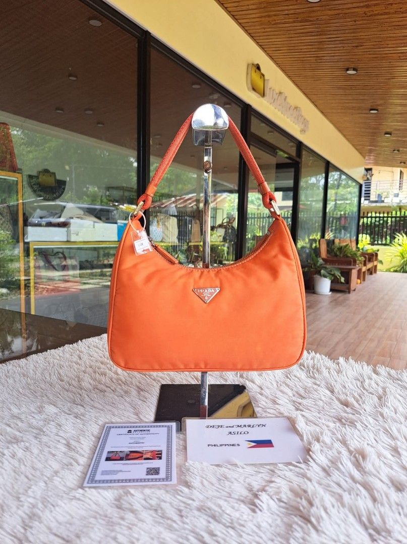 Prada Orange Nylon Hobo Bag (Category: Luxury Bags & Wallets) located in Tagum. Submitted by marny0503-00673 (Listing ID 1446370800, Image 1). Description: 💠💠💠 Authentic/Original 💠💠💠 Re-Edition Tessuto Mini Baguette Bag, Pre-owned‼️‼️👜👜 Inclusions: ✅️ COA ✅️ Paypal fee/deduction ➕️ shipping fee depends on the country through DHL. Tariff is excluded. Please check your recent address if the same in your paypal address it should be the same 
