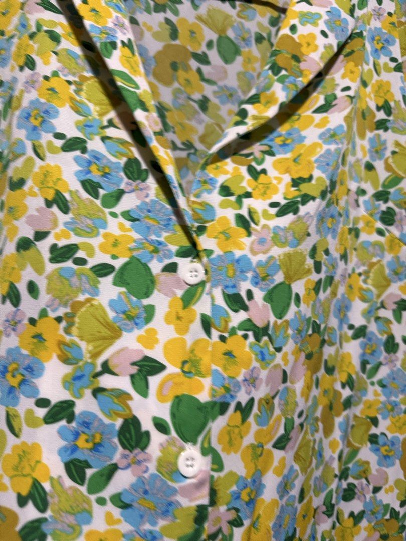 SHEIN Floral Print Button-Up Shirt (Category: Blouses) located in Quezon City. Submitted by KK_declutterluxx (Listing ID 1446445979, Image 3). Description: - Cute floral print top from SHEIN - Features yellow, blue, and green flowers on a white background - Collared neckline with button-up front - Short puff sleeves - Lightweight fabric, ideal for warm weather - Versatile styling with jeans or shorts - ksya large to xl - used but not abused Sf c/