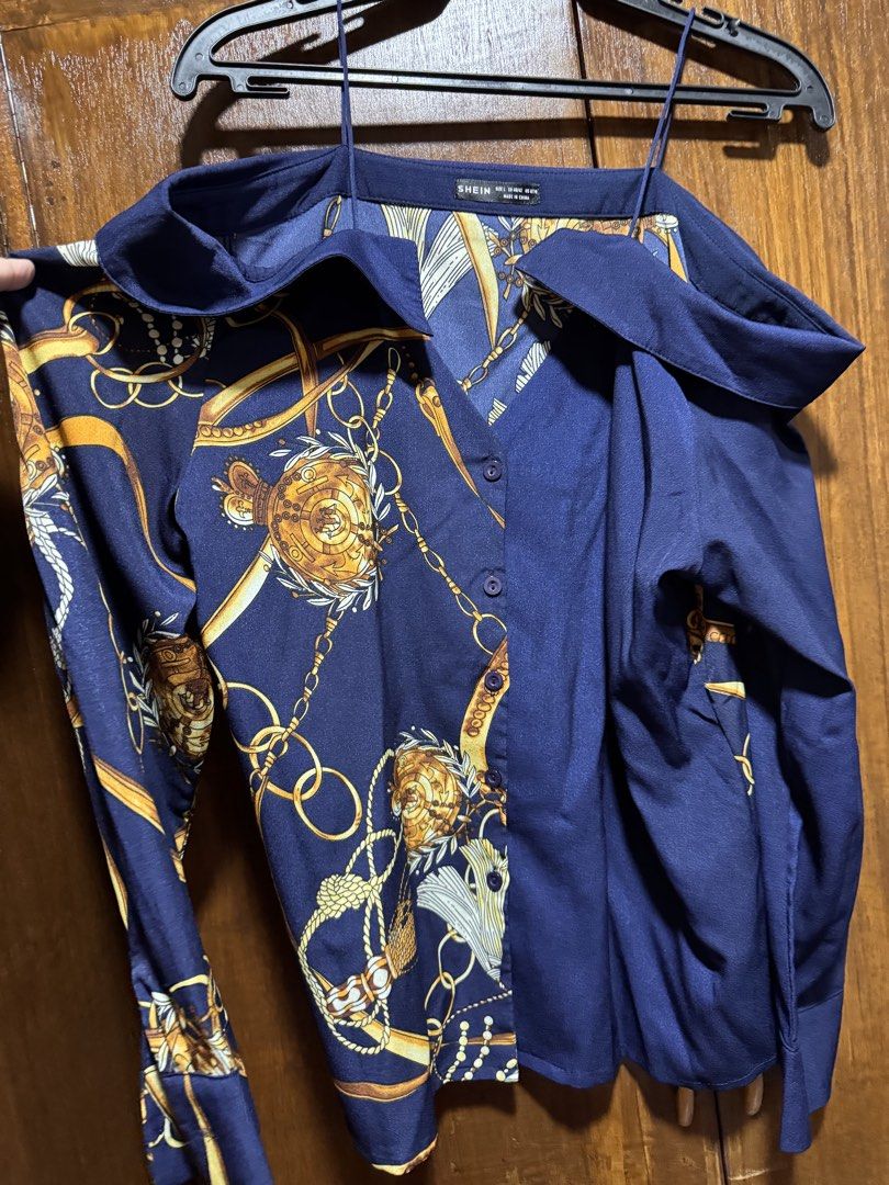 SHEIN Navy Blue Chain Print Button-Up Shirt (Category: Shirts) located in Quezon City. Submitted by KK_declutterluxx (Listing ID 1446445268, Image 2). Description: - Navy blue longsleeves from SHEIN - Features a stylish gold chain print - Button-up front - Long sleeves - Designed to look like a layered piece - Perfect for dressing up or down - never been used - large to xl frame Sf c/o buyer.