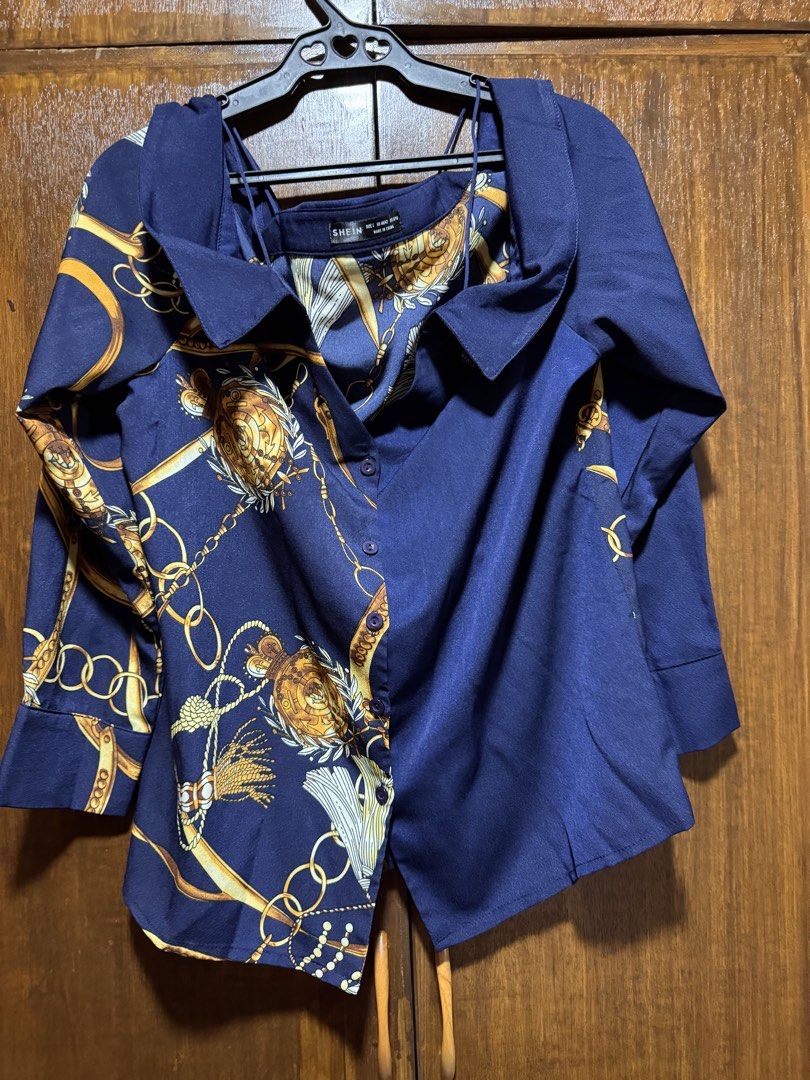 SHEIN Navy Blue Chain Print Button-Up Shirt (Category: Shirts) located in Quezon City. Submitted by KK_declutterluxx (Listing ID 1446445268, Image 1). Description: - Navy blue longsleeves from SHEIN - Features a stylish gold chain print - Button-up front - Long sleeves - Designed to look like a layered piece - Perfect for dressing up or down - never been used - large to xl frame Sf c/o buyer.