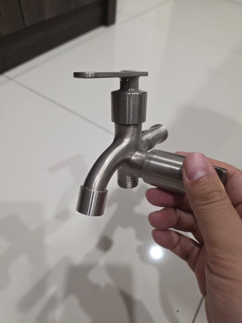 Stainless Steel Faucet with Dual Outlets (Category: Bathroom & Kitchen Fixtures) located in Klang. Submitted by ray3231989 (Listing ID 1446349471, Image 1). Description: - Durable stainless steel construction - Dual water outlets for versatility - Smooth, easy-to-operate handle - Comes with an extra threaded piece - Ideal for kitchen or bathroom upgrades and renovations.