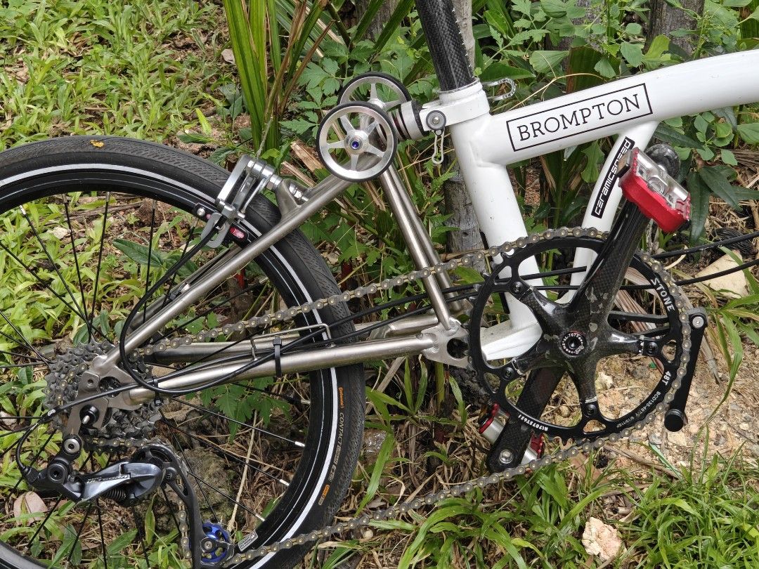 Titanium 'Brompton' (Category: Bicycles) located in Singapore. Submitted by kryptonit (Listing ID 1446351423, Image 2). Description: - Titanium frame in white 2k paint - Titanium Fork, Titanium Stem - Titanium Rear Triangle - Ultegra 9 Speed Shifters & Derailleur - 20 inch Wheelset with 11-48T Cogs - Continental Tyres - Carbon Crankset, Titanium BB - Ultralight Folding Pedals - Carbon M Handlebar - Litepro Carbon Seatpost - Ultralight Seat - Ultr