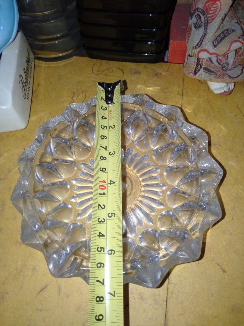 Vintage Crystal Glass Ashtray with Geometric Pattern (Category: Other Home Decor) located in Cardona. Submitted by nick_and_maria (Listing ID 1446467986, Image 2). Description: - Heavy glass ashtray - Features a detailed geometric pattern - Measures approximately 6 inches in diameter - Perfect for collectors or as a decorative item.