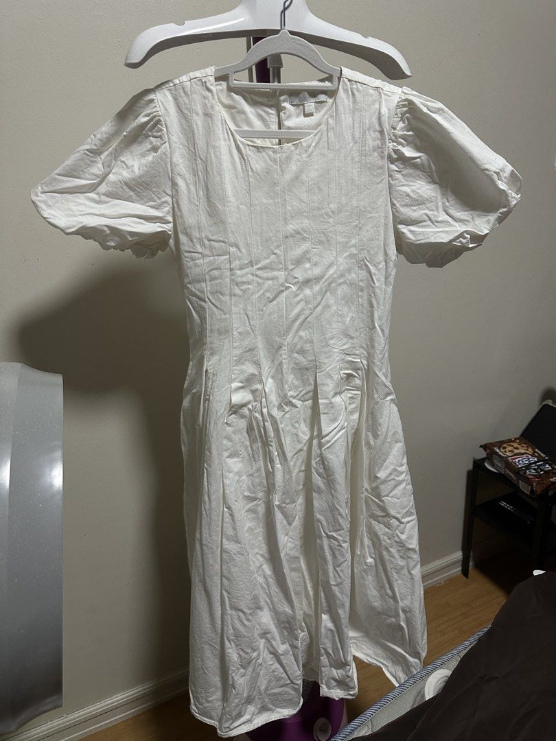 White Puff Sleeve Midi Dress (Category: Dresses) located in Quezon City. Submitted by flores09 (Listing ID 1446452444, Image 1). Description: - Elegant white midi dress - Stylish puff sleeves with ruffled hem - Flattering vertical pintuck details on the bodice - Flowy pleated skirt for a graceful look - Versatile for dressing up or down - Comfortable and chic for any occasion - purchased from Anthropologie in US .