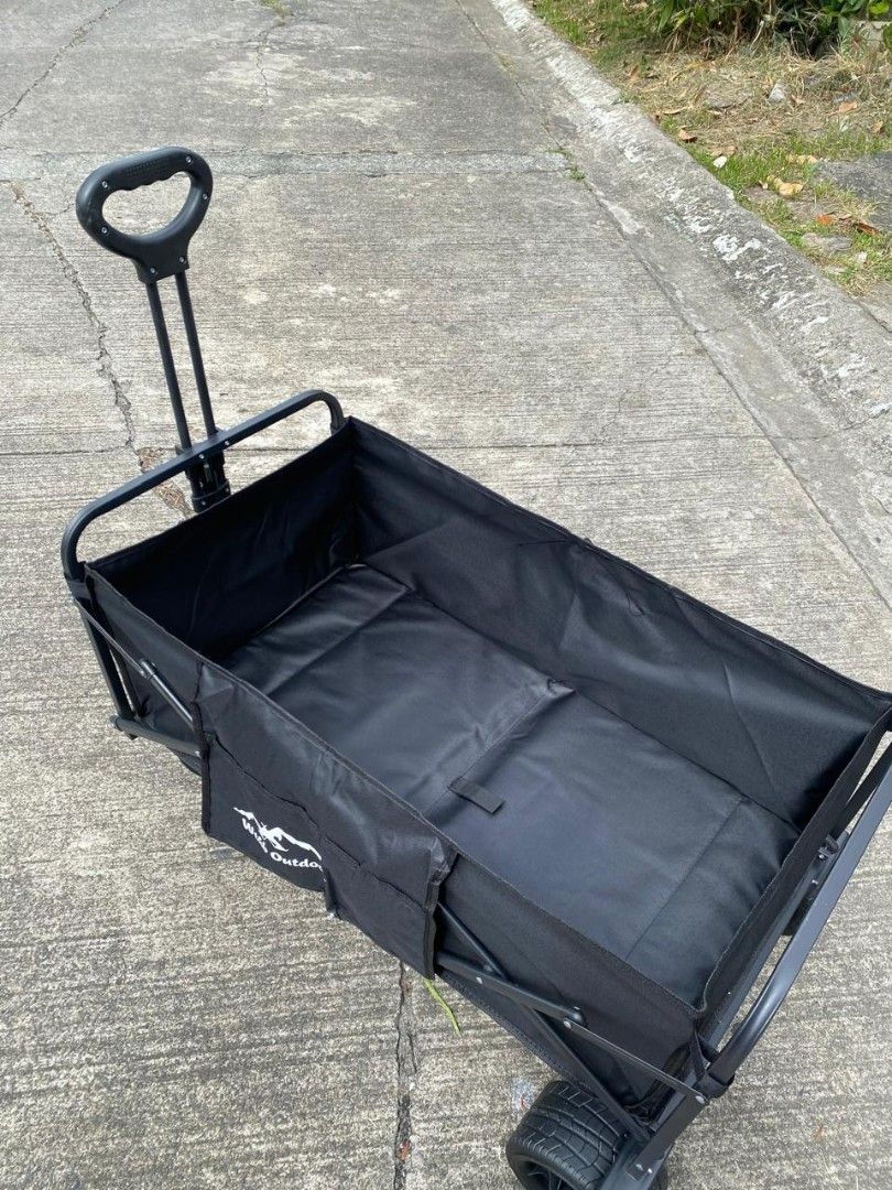 Wild Outdoor Folding Wagon Cart - Black (Category: Hiking & Camping) located in Manila. Submitted by shairatorres (Listing ID 1446346749, Image 2). Description: - Versatile: Ideal for camping, beach trips, or grocery hauling. - Convenient: Folds and sets up easily for storage and use. - Durable: Made with sturdy fabric and a strong frame. - Portable: Features a handle and wheels for effortless pulling and moving. - All-Purpose Hauler: Take it any