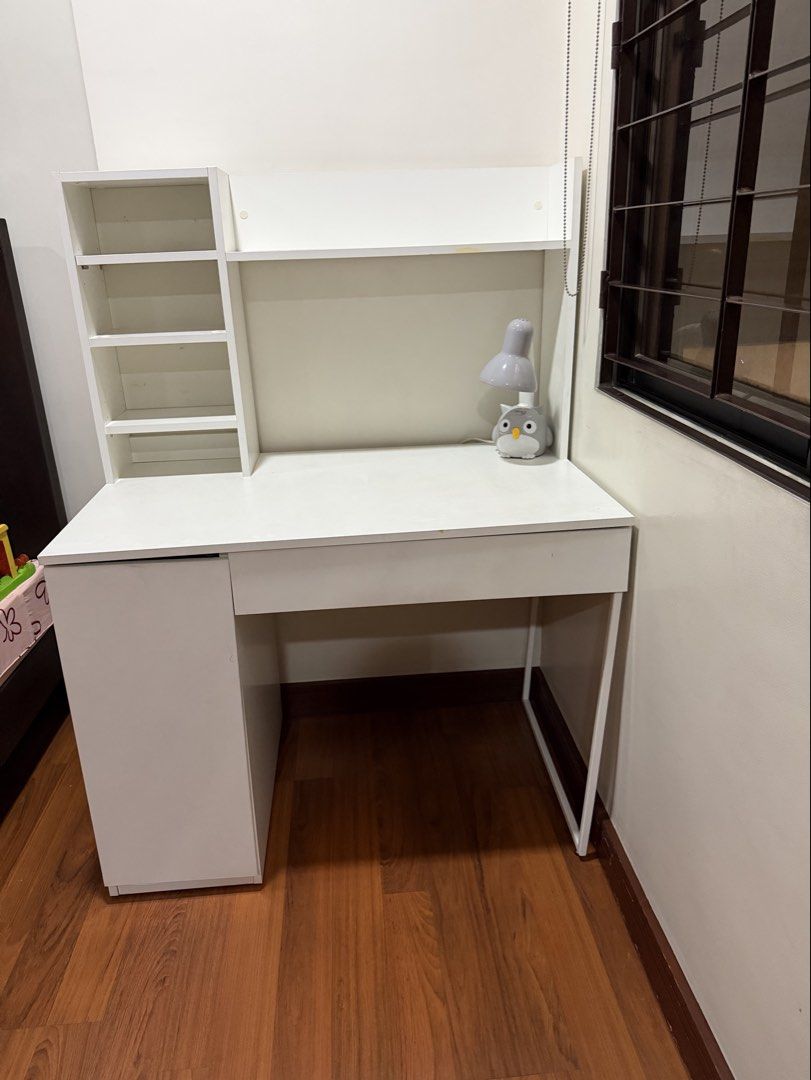 Working Table (Category: Other Home Furniture) located in Quezon City. Submitted by mycloset2yours82 (Listing ID 1446451685, Image 1). Description: IKEA Working Table Color: White Condition: With flaws (misaligned cabinet and drawer, crack on the side) Side shelves are adjustable in height FREE: AKARI desk lamp (shown in photo) RFS: renovating son’s room Buyer shoulder shipping. Pick up in QC.