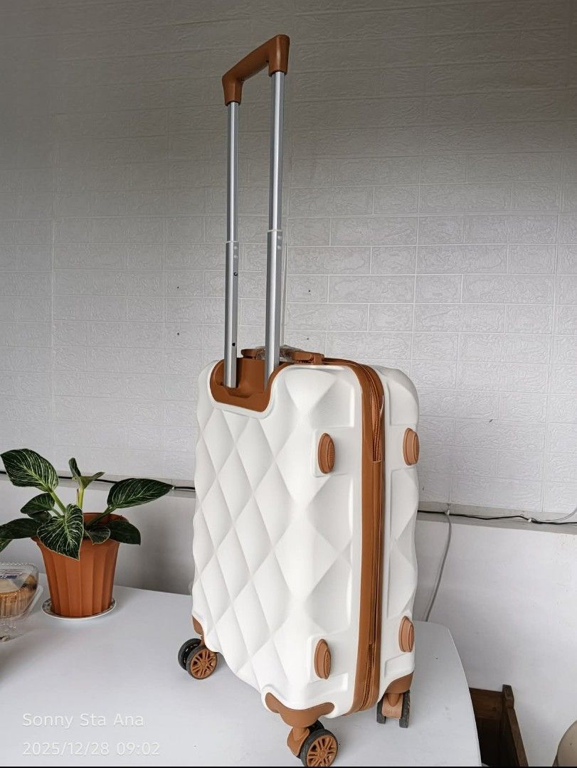 1time used-White Diamond Pattern Hardshell Luggage with Brown Accents (Category: Luggage) located in Quezon City. Submitted by gadgetsun (Listing ID 1446541329, Image 2). Description: - Stylish white hardshell luggage with a chic diamond pattern. - Elegant brown trim and detailing for a sophisticated look. - Secure your belongings with the built-in combination lock. - Effortless mobility to smooth-rolling wheels. - Convenient telescopic handle fo