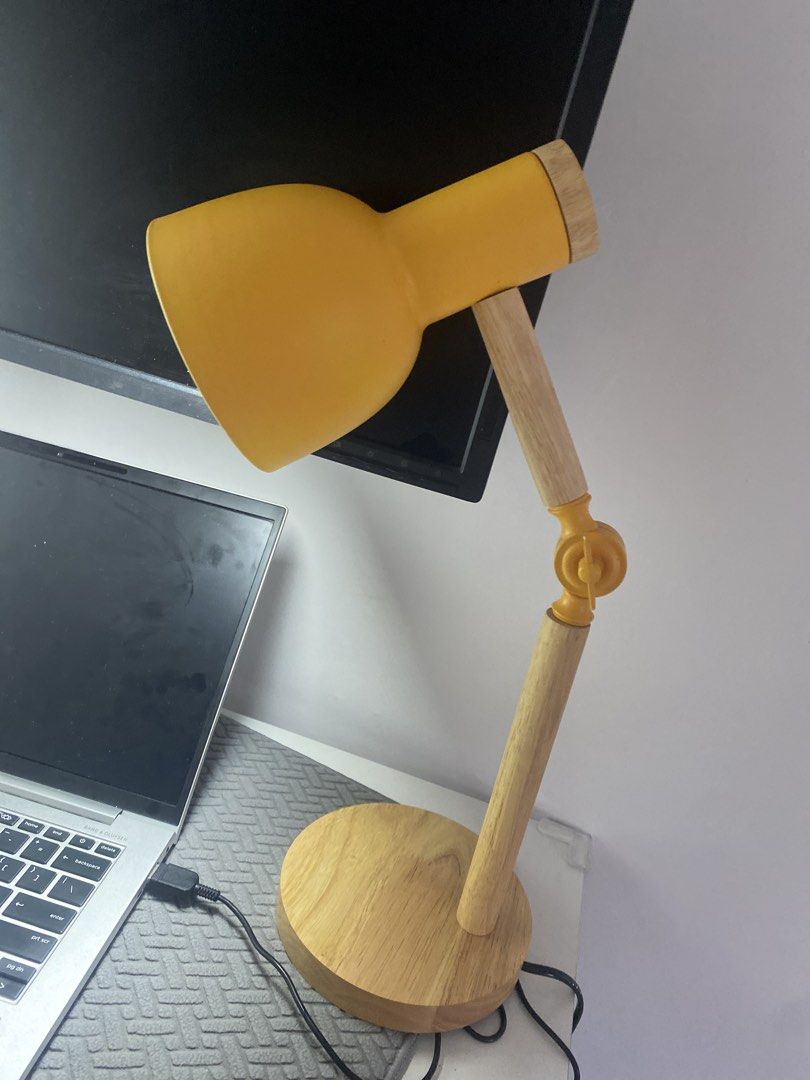 Adjustable Desk Lamp with Wooden Base - Yellow (Category: Lighting) located in Taguig. Submitted by ceej0915 (Listing ID 1446626276, Image 3). Description: - Bright yellow desk lamp - Sturdy wooden base - Adjustable arm for perfect lighting - Excellent working condition - Includes power cord - Perfect for study desks or bedside tables.