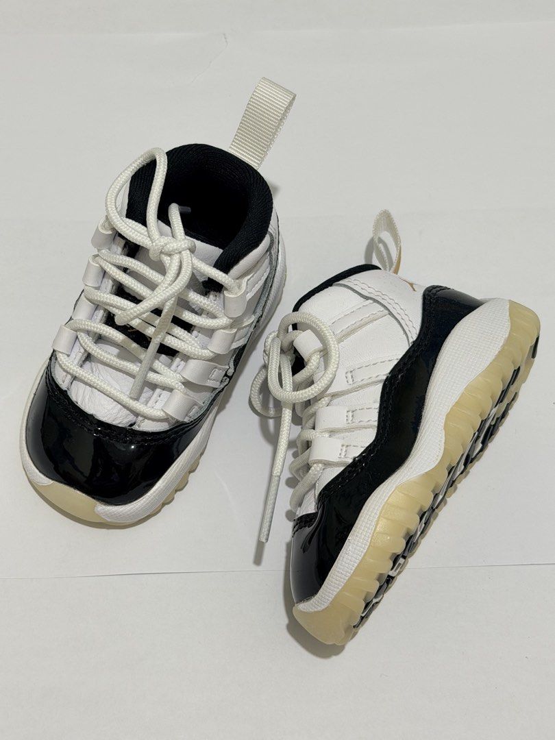 Air Jordan 11 Retro Toddler (Category: Babies & Kids Fashion) located in Pasig City. Submitted by myprelovedcorner (Listing ID 1446678636, Image 2). Description: - Air Jordan 11 Retro Toddler Shoes - Classic black and white colorway - Patent leather toe box - Lace-up front closure - Heel pull tab for easy on/off - Translucent very clean sole; hindi na apak sa floor ever - Size: 3c | 9cm - Used once during photoshoot lang. Never na- i lakad sa flo
