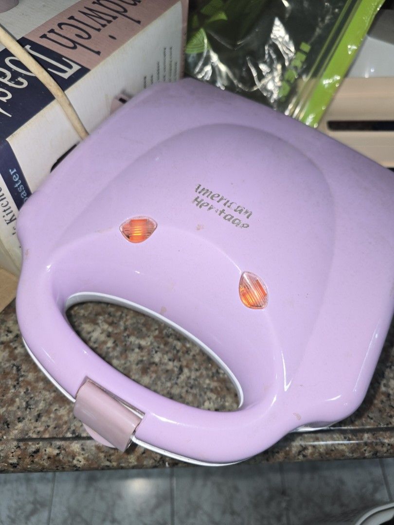 American Heritage Sandwich Toaster Maker (Category: Ovens & Toasters) located in Caloocan City. Submitted by mluck (Listing ID 1446638867, Image 2). Description: - American Heritage waffle maker - Makes 4 mini sandwiches at a time - Indicator lights are functional - Plates show some residue from use - Comes with original packaging - Ideal for preparing quick and easy snacks.