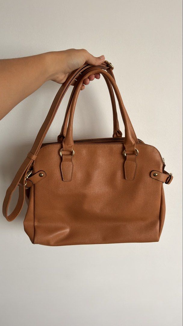 Anne Klein Tan Satchel Handbag with Shoulder Strap (Category: Shoulder Bags) located in Manila. Submitted by shopce (Listing ID 1446548065, Image 2). Description: Anne klein satchel bag (preloved) Anne Klein tan textured satchel. Top handles, adjustable strap. Interior zip and slip pockets. Minor interior marks. Gold hardware. Perfect everyday bag. - in pristine condition - used thrice only - bought it in marketplace also - flaws meron rust sa me