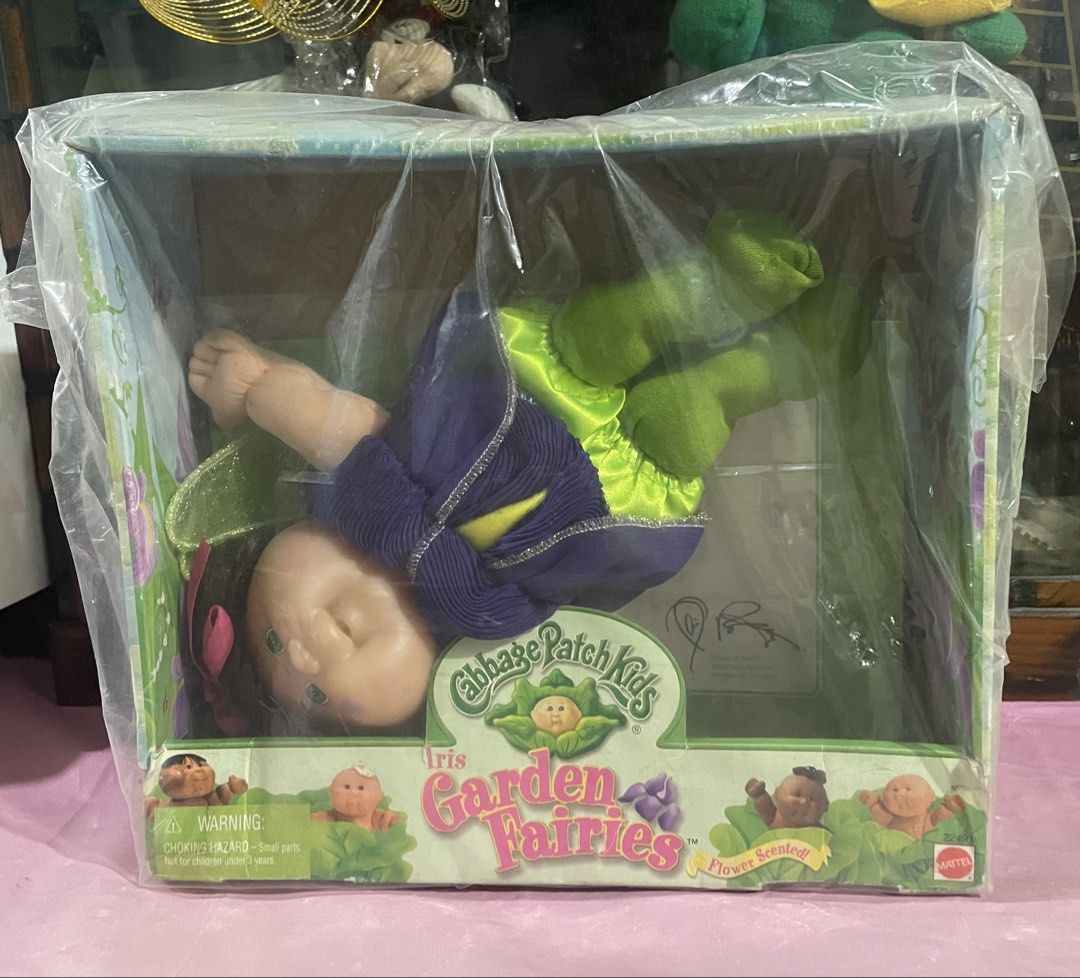 Authentic Cabbage Patch Garden Fairy Doll (Category: Figurines & Statues) located in Manila. Submitted by prelovedpicksph (Listing ID 1446715631, Image 1). Description: — in good condition, minimal flaw — flaw includes: ripped off portion of the back, box is still intact (see 2nd pic for reference) — Cabbage Patch Garden Fairy: Iris — wrapped in plastic.