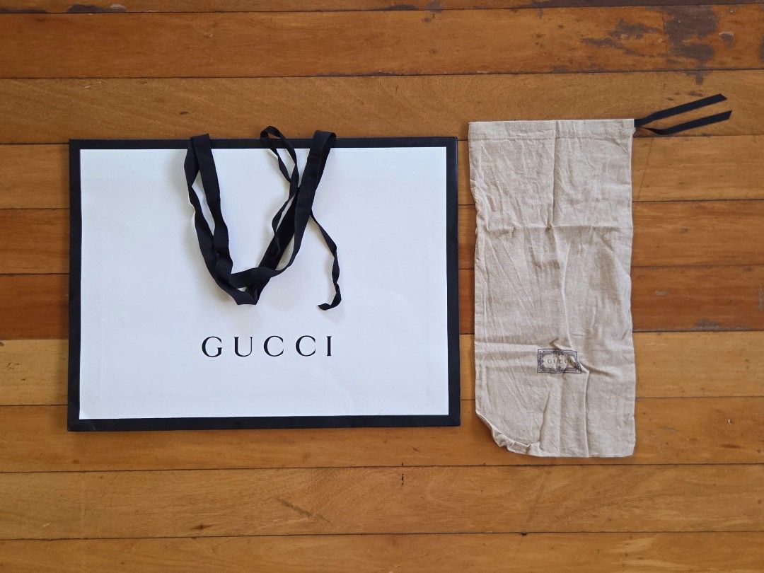 Authentic Gucci Paper Bag Set (Slim Classic) (Category: Luxury Bags & Wallets) located in Pasig City. Submitted by ge_borro (Listing ID 1446704799, Image 1). Description: Authentic Gucci Store slim paper bag and dust bag Paper Bag: 19 by 14 by 3.25 inches Dust Bag: 16.5 by 8 inches In good condition, with minor signs of storage *Packaging materials only, Gucci Product not included.
