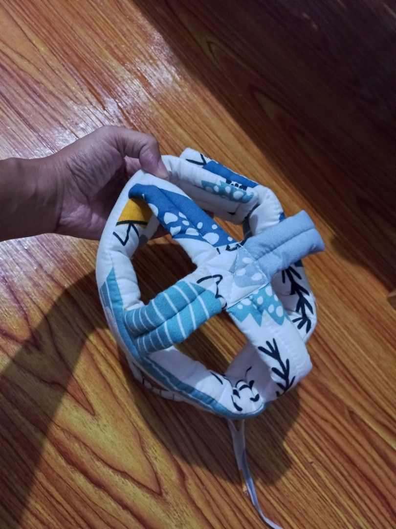 Baby Head Protector Pillow for Crawling Toddlers (Category: Children's Beds) located in Manila. Submitted by enzierose (Listing ID 1446632569, Image 3). Description: - Protects baby's head during falls while learning to crawl or walk. - Features adjustable straps for a secure and comfortable fit. - Adorable blue and white patterned design. - Provides peace of mind for parents..
