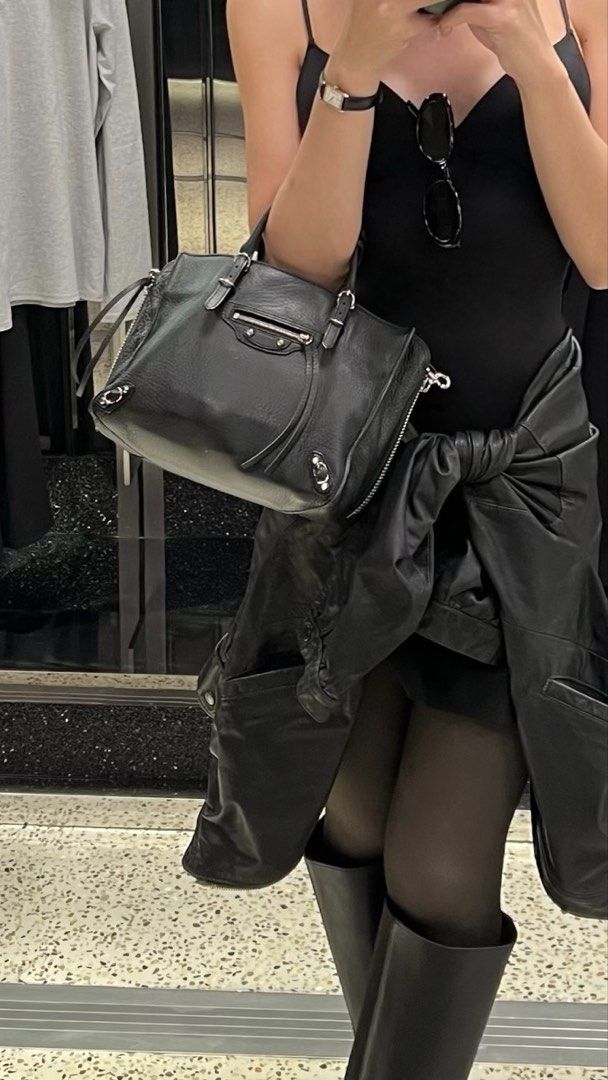BALENCIAGA MINI PAPIER BAG (Category: Luxury Bags & Wallets) located in Quezon City. Submitted by __n1kki (Listing ID 1446718055, Image 3). Description: - Classic Balenciaga black leather bag - Features top handles - Detachable shoulder strap included - Iconic mirror charm - Spacious interior - Silver-tone hardware - Ideal for everyday use - Comes with original dust bag Meetup available along QC area.