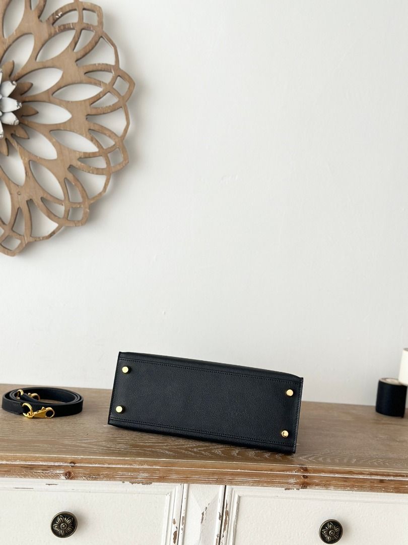 Black Leather Handbag with Gold Hardware (Category: Luxury Bags & Wallets) located in San Juan City. Submitted by mulakibebb18615 (Listing ID 1446624447, Image 3). Description: - Classic black leather handbag - Top handle and detachable shoulder strap - Gold-tone hardware (clasp and feet) - Structured design - Spacious interior - Versatile for daily use or special occasions.