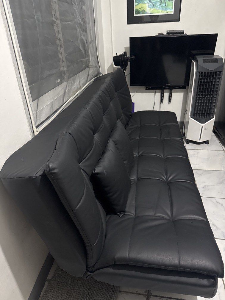 Black Leather Sofa Bed with 2 (Category: Sofas) located in Mandaluyong City. Submitted by iamtinkerbell (Listing ID 1426927094, Image 3). Description: - Black leather sofa - Tufted design - Includes two square pillows - Modern design with silver legs - Perfect for living rooms or lounges - Comfortable and elegant.