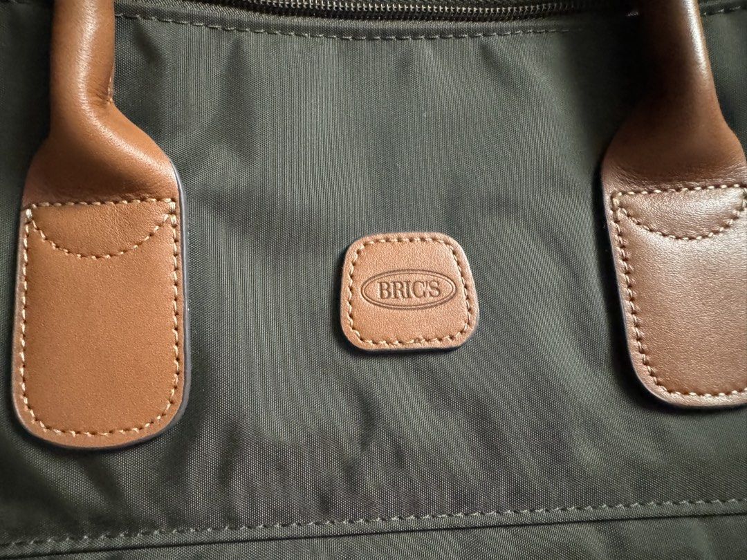 BRICS MILANO Olive Green Duffel Bag (Category: Luxury Bags & Wallets) located in Muntinlupa City. Submitted by shopaholicstill (Listing ID 1446538954, Image 2). Description: BRICS MILANO X-Travel/X-Collection 22-inch Weekend Holdall Olive green duffel bag Made from water-resistant satin nylon with leather finishes, equipped with a rear trolley sleeve for easy attachment to luggage handles. Dimensions: 32 cm x 55 cm x 20 cm comes with detachable p