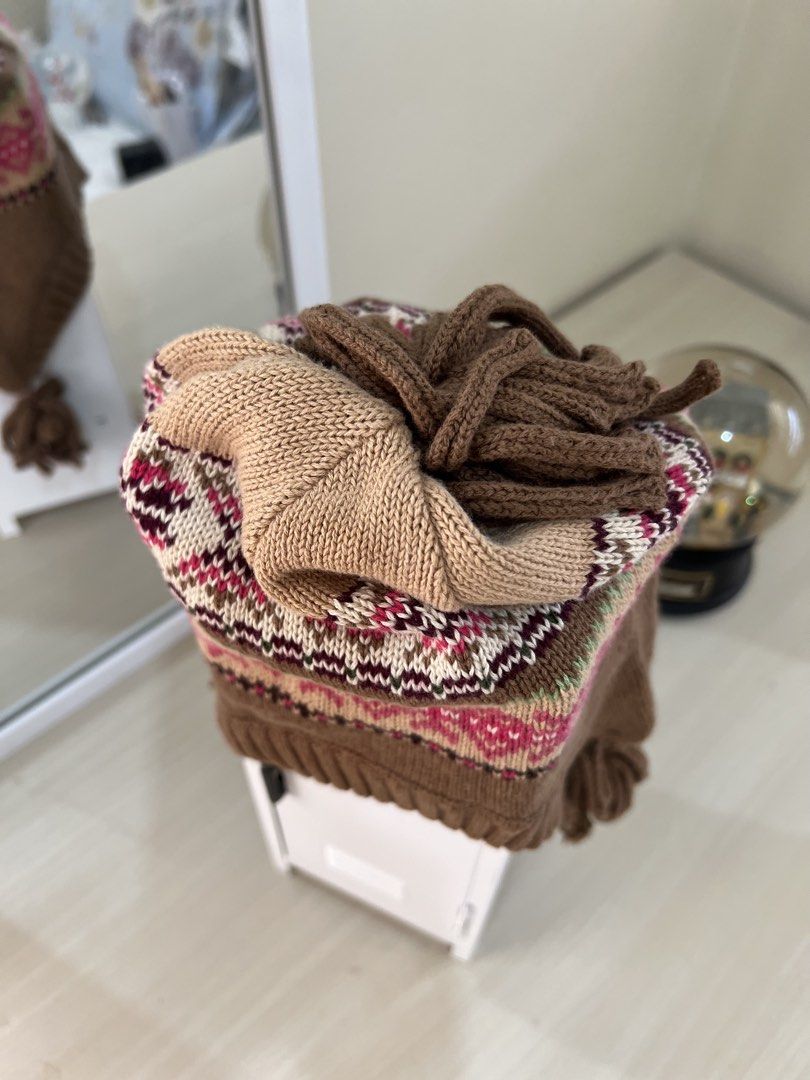 Brown Knit Beanie with Tassels and Fair Isle Pattern (Category: Hats & Beanies) located in Makati City. Submitted by esila.essentials (Listing ID 1446627232, Image 2). Description: - Cozy brown knit beanie - Features a colorful Fair Isle pattern around the band - Adorable tassels on the sides - Ideal for keeping warm during cooler weather.