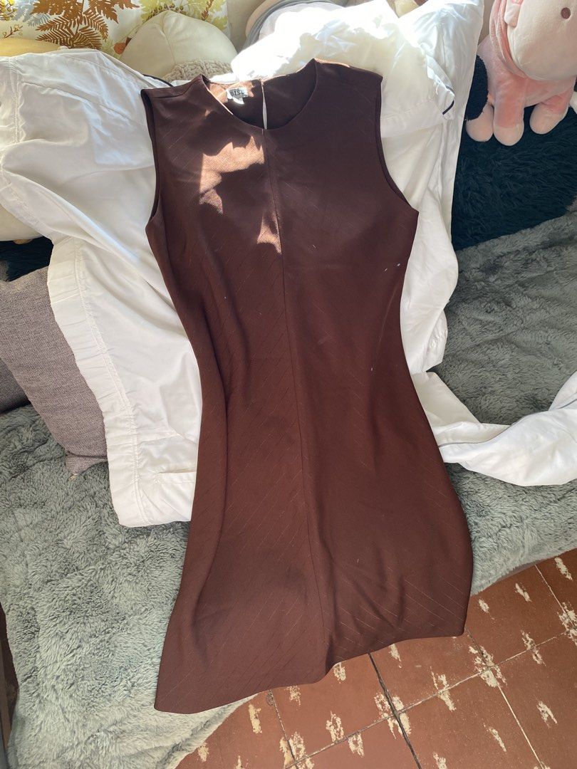 Brown Sleeveless Sheath Dress (Category: Dresses) located in Quezon City. Submitted by declutter.repsaj (Listing ID 1446657924, Image 1). Description: - Simple brown sleeveless dress - Classic sheath silhouette - Subtle textured fabric pattern - Zipper closure at the back - Versatile for work or casual outings.