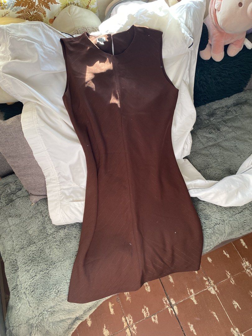 Brown Sleeveless Sheath Dress (Category: Dresses) located in Quezon City. Submitted by declutter.repsaj (Listing ID 1446657924, Image 2). Description: - Simple brown sleeveless dress - Classic sheath silhouette - Subtle textured fabric pattern - Zipper closure at the back - Versatile for work or casual outings.