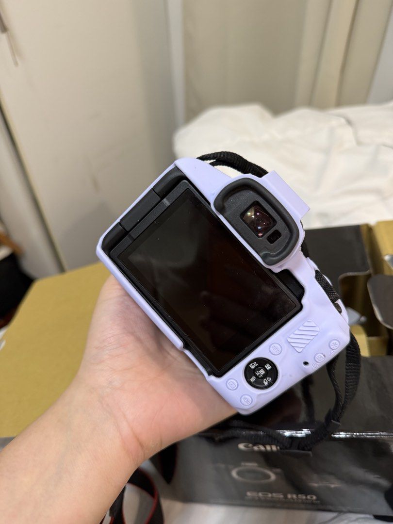 Canon EOS R50 Mirrorless Camera with Lens (Category: Cameras) located in Manila. Submitted by shoptilyoudrop12 (Listing ID 1446707833, Image 2). Description: - Canon EOS R50 camera in a light purple color silicone case - Includes original lens - Perfect for beginners or those seeking a compact camera - Clear screen and fully functional buttons - Comes complete with box manual and everything.