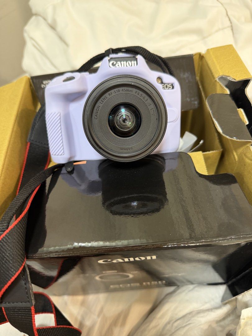 Canon EOS R50 Mirrorless Camera with Lens (Category: Cameras) located in Manila. Submitted by shoptilyoudrop12 (Listing ID 1446707833, Image 3). Description: - Canon EOS R50 camera in a light purple color silicone case - Includes original lens - Perfect for beginners or those seeking a compact camera - Clear screen and fully functional buttons - Comes complete with box manual and everything.