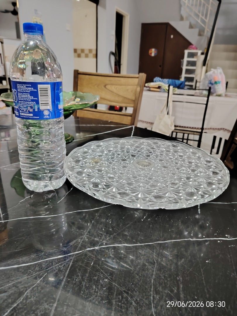 Clear Glass Cake Stand with Intricate Pattern (Category: Other Kitchenware & Tableware) located in Petaling Jaya. Submitted by junkerwalk (Listing ID 1446547031, Image 2). Description: - Beautiful clear glass cake stand - Features an all-over geometric pattern - Ideal for displaying cakes, desserts, or pastries - Doubles as a decorative centerpiece - Sturdy and well-made construction - Perfect for parties or everyday use - The item is almost 19 y