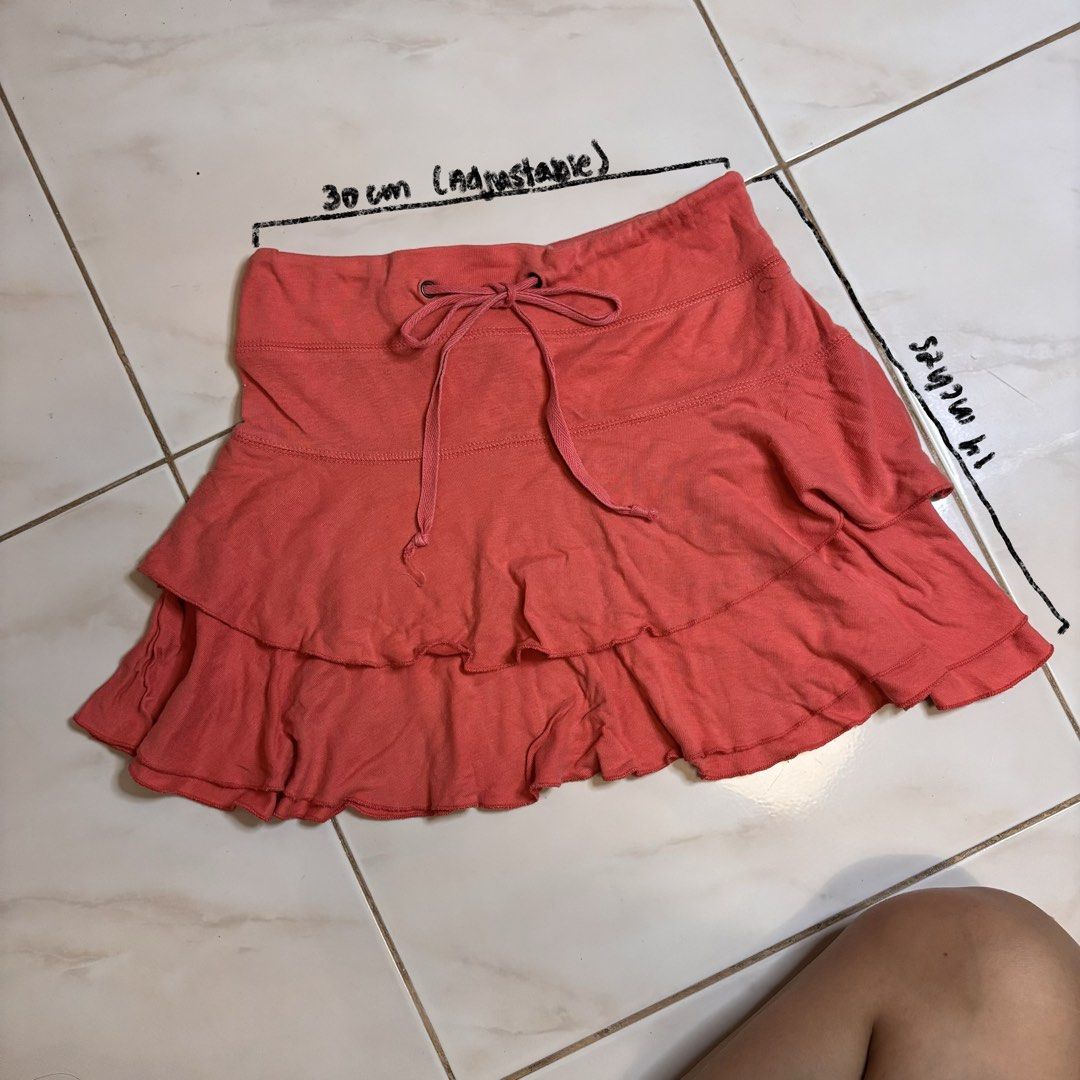 Coral Ruffled Mini Skirt with Drawstring Waist (Category: Skirts) located in Manila. Submitted by vvyein_ (Listing ID 1446630339, Image 1). Description: - Adorable coral mini skirt - Features a cute ruffled hem - Adjustable drawstring waist for a perfect fit - Made from soft and comfortable fabric - Ideal for casual everyday wear - Measurements: Approx. 30cm waist, 14 inches length - Versatile and easy to pair with various tops.
