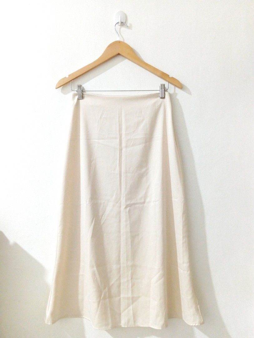 Cream A-line Midi Skirt (Category: Skirts) located in Manila. Submitted by cococlo_ (Listing ID 1446674048, Image 1). Description: - Simple cream midi skirt - Flattering A-line cut - Hangs nicely, drapes well - Versatile for various outfits - Suitable for dressing up or down - Easy to style.